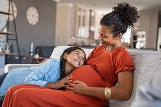 pregnent mother with daughter